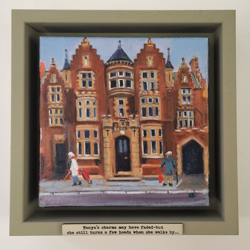 “Tanya’s Charms” original Owd Lasses painting by British artist Sue Dewhurst featuring an older woman walking past a grand Yorkshire pub in Richmond. Image Title