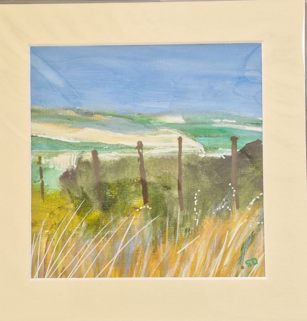 Fenceline original mixed media landscape by Sue Dewhurst showing weathered fence posts, golden field grasses and distant green hills beneath a blue sky.